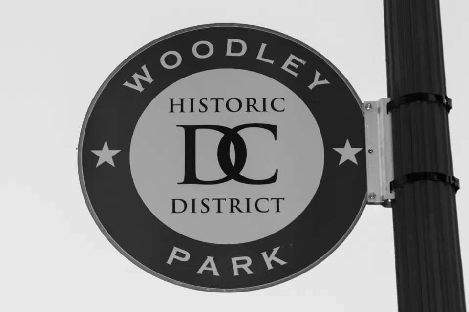 A sign on the side of a street light reads “Woodley Park Historic District D.C.”